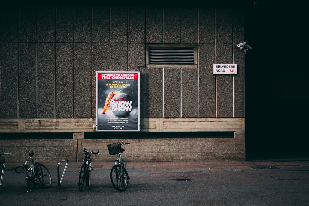 bicycle-parked-near-concrete-wall-clghnorloa0
